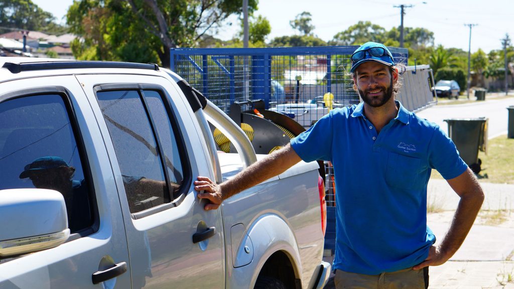 Gutter Suction technician standing at his ute